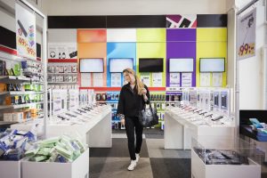 Mujer buscando un celular en tienda de tecnología (Getty Images)
